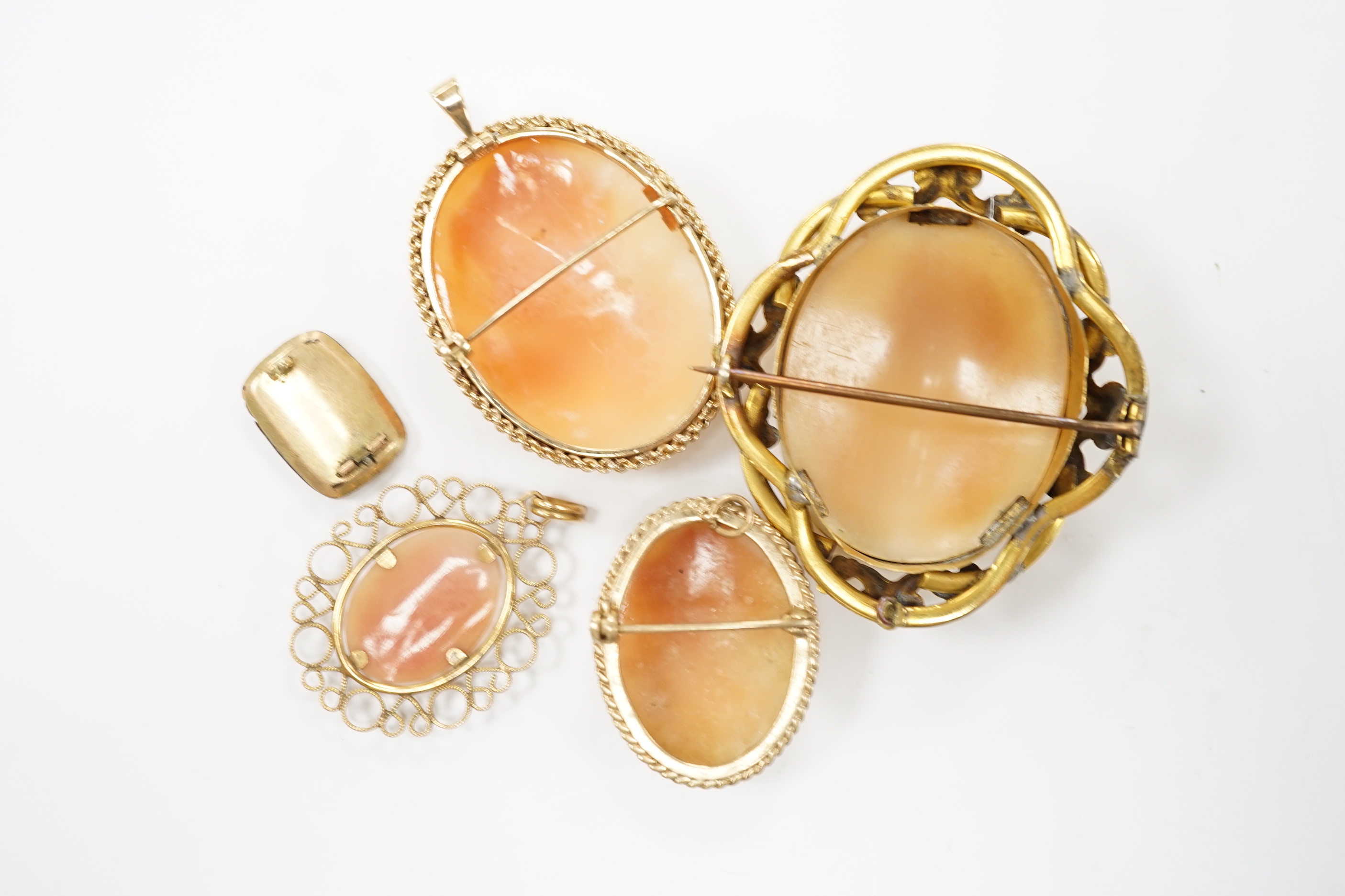 Two modern 9ct gold mounted oval cameo shell pendant brooches, largest 42cm and two other mounted oval cameo shell pendant or brooches and a mourning brooch (a,f,).